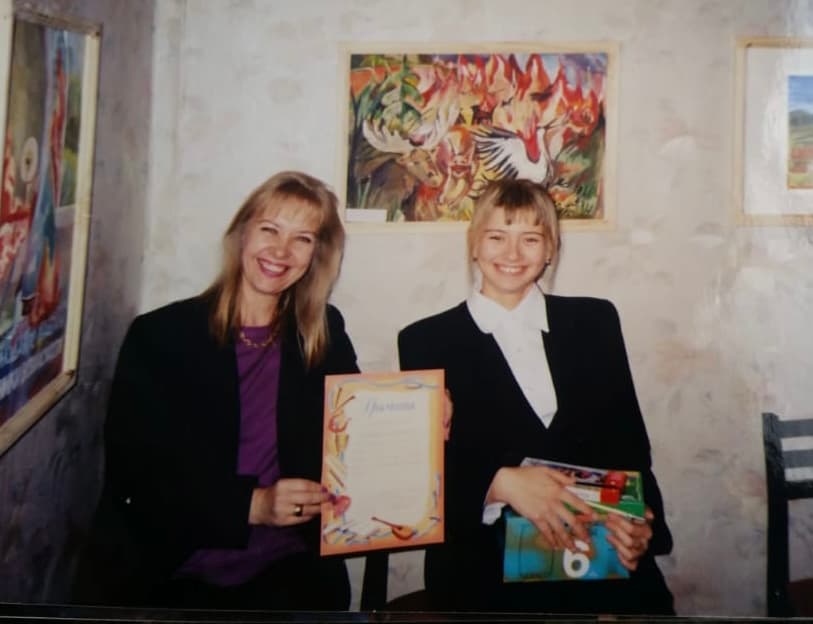Victoria sitting next to her mom after receiving an art award