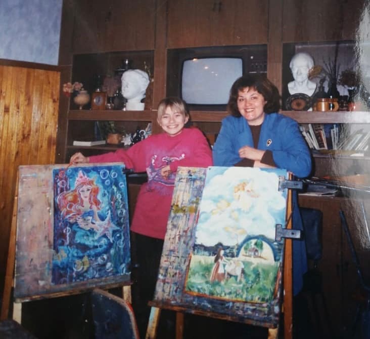 Victoria with art teacher Natalia Mamardashvili and winning works